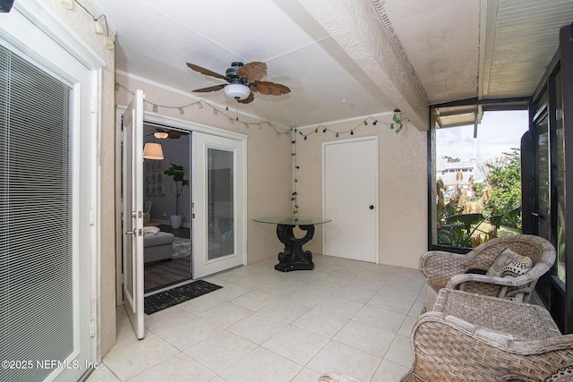 sunroom featuring ceiling fan