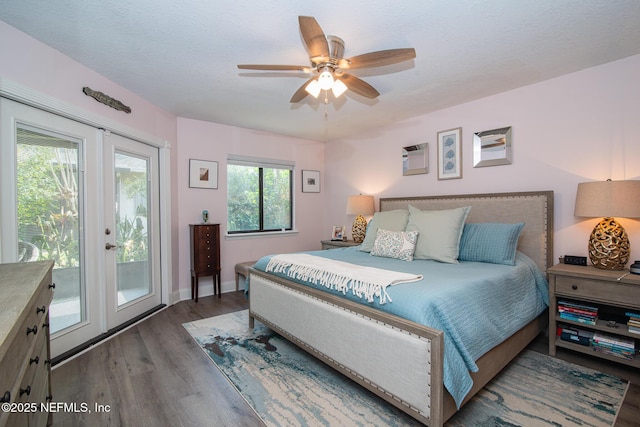 bedroom featuring dark hardwood / wood-style floors, access to exterior, ceiling fan, and french doors