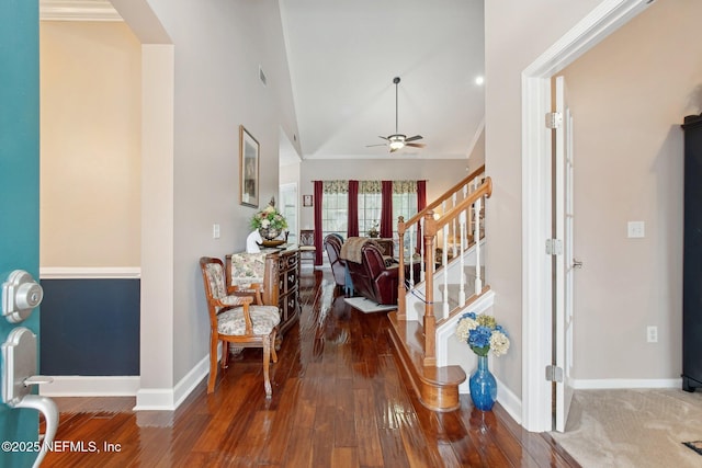 foyer entrance with ceiling fan, stairway, baseboards, and wood finished floors