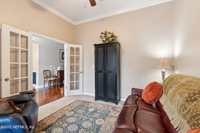 living room featuring ornamental molding, carpet floors, french doors, and baseboards