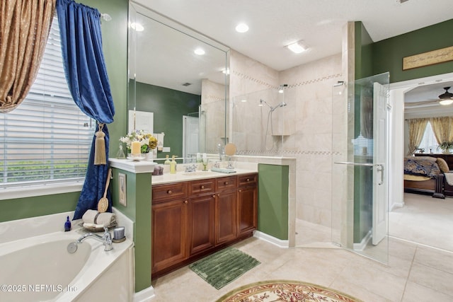 full bath featuring a stall shower, tile patterned flooring, vanity, and a bath