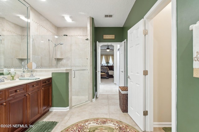 bathroom with a shower stall, vanity, visible vents, and ensuite bathroom