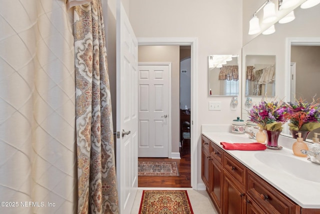 full bath featuring a sink and double vanity