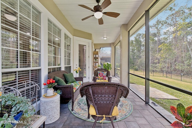 sunroom with a ceiling fan