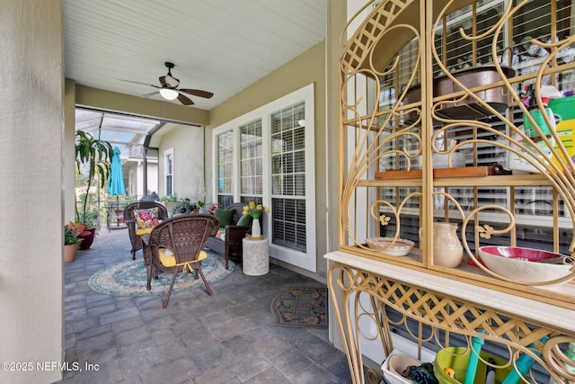 sunroom featuring a ceiling fan