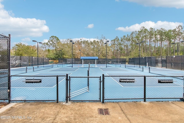 view of sport court with fence and a gate