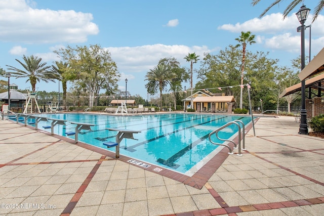 pool with a patio and fence