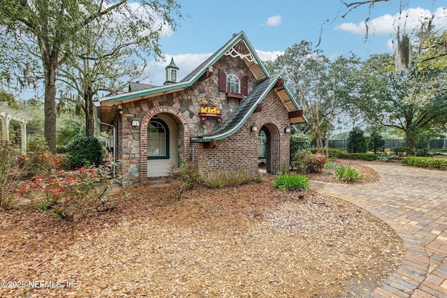 view of front facade featuring stone siding and brick siding