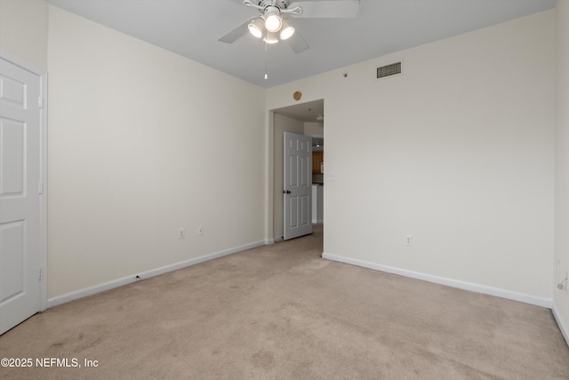 carpeted empty room featuring ceiling fan