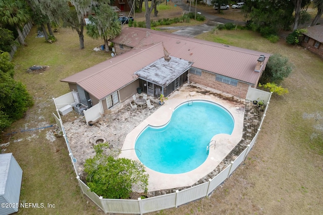 view of pool with a lawn and a patio