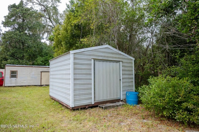 view of outdoor structure with a lawn