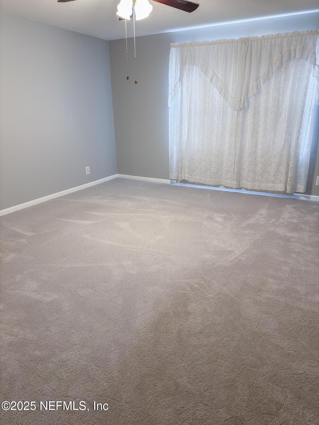 spare room with carpet flooring and ceiling fan