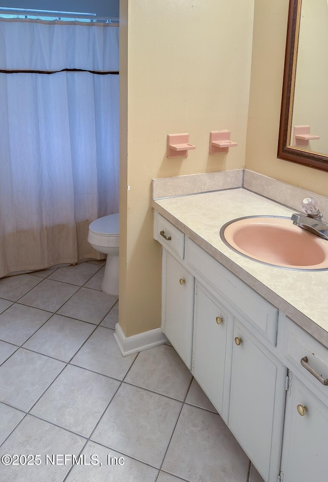 bathroom featuring tile patterned flooring, vanity, a shower with curtain, and toilet