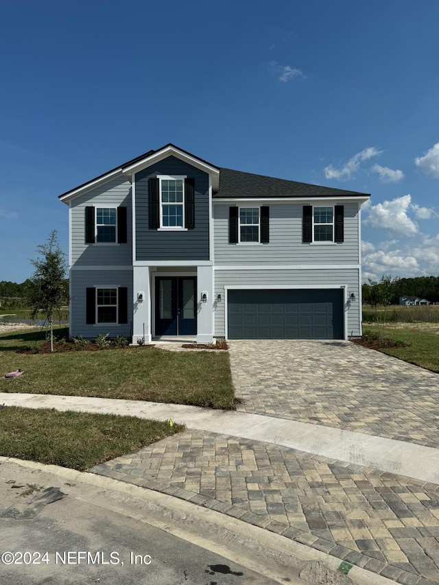 view of front property with a garage and a front yard