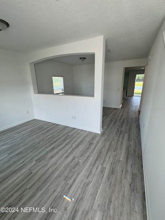 spare room with wood-type flooring and a textured ceiling