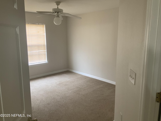 carpeted empty room featuring ceiling fan