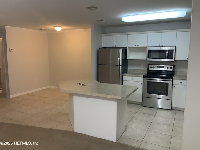 kitchen with white cabinetry, appliances with stainless steel finishes, light tile patterned flooring, and kitchen peninsula