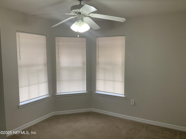 spare room with a healthy amount of sunlight, carpet flooring, and ceiling fan