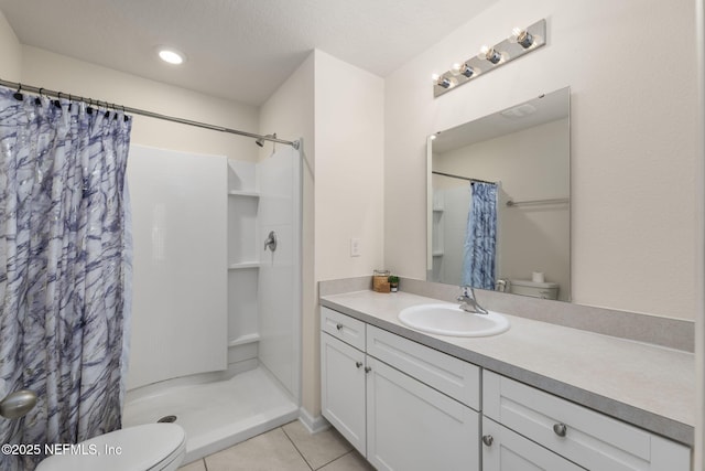 bathroom featuring tile patterned flooring, vanity, toilet, a textured ceiling, and a shower with curtain