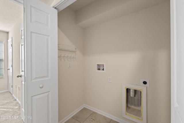 clothes washing area with hookup for a washing machine, hookup for an electric dryer, and light tile patterned floors