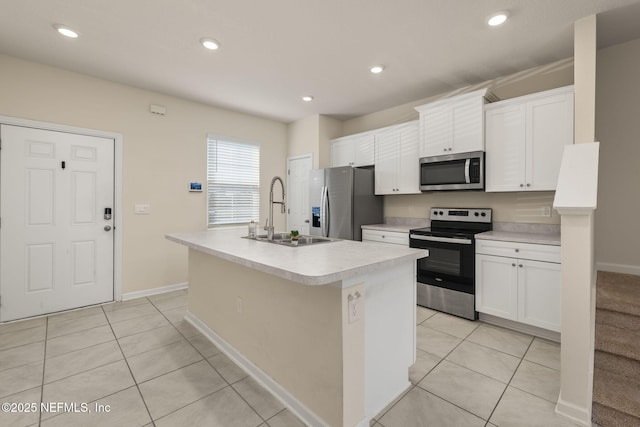 kitchen featuring white cabinetry, appliances with stainless steel finishes, sink, and a center island with sink