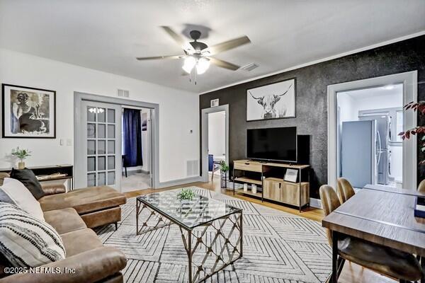 living room with light wood-type flooring and ceiling fan