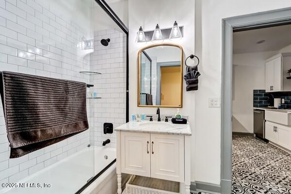 bathroom featuring enclosed tub / shower combo, vanity, and tile patterned floors