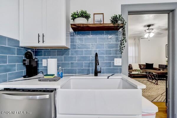 kitchen featuring sink, white cabinetry, dishwasher, ceiling fan, and decorative backsplash