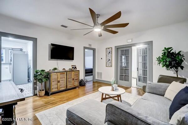 living room featuring hardwood / wood-style floors and ceiling fan