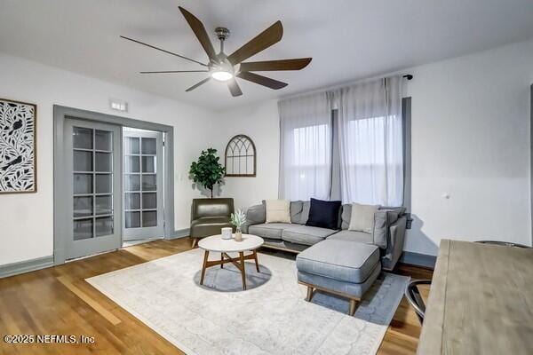 living room with hardwood / wood-style flooring and ceiling fan