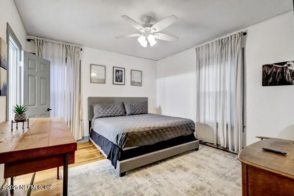 bedroom with light hardwood / wood-style flooring and ceiling fan