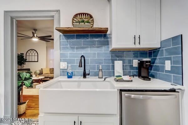 kitchen with white cabinetry, stainless steel dishwasher, ceiling fan, and sink