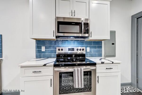 kitchen featuring stainless steel appliances and white cabinetry