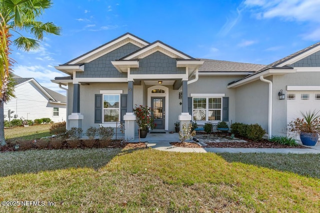 view of front of house featuring a garage and a front lawn