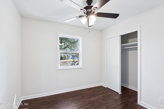 unfurnished bedroom with dark wood-type flooring, a closet, and ceiling fan