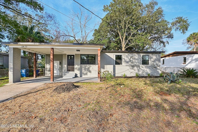 view of front of property featuring a carport