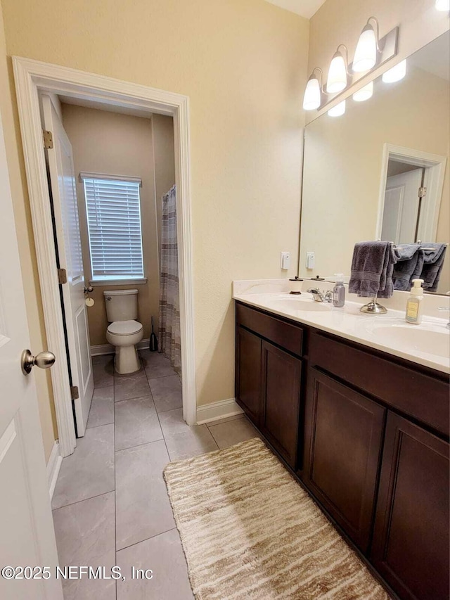 bathroom featuring vanity, tile patterned flooring, curtained shower, and toilet