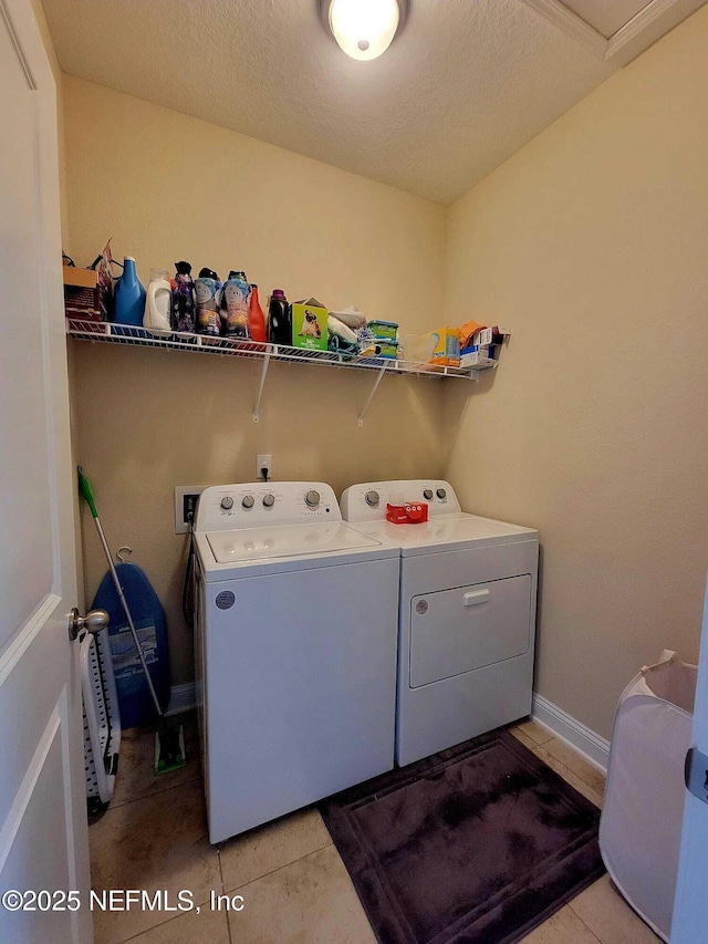 laundry room with separate washer and dryer and light tile patterned floors