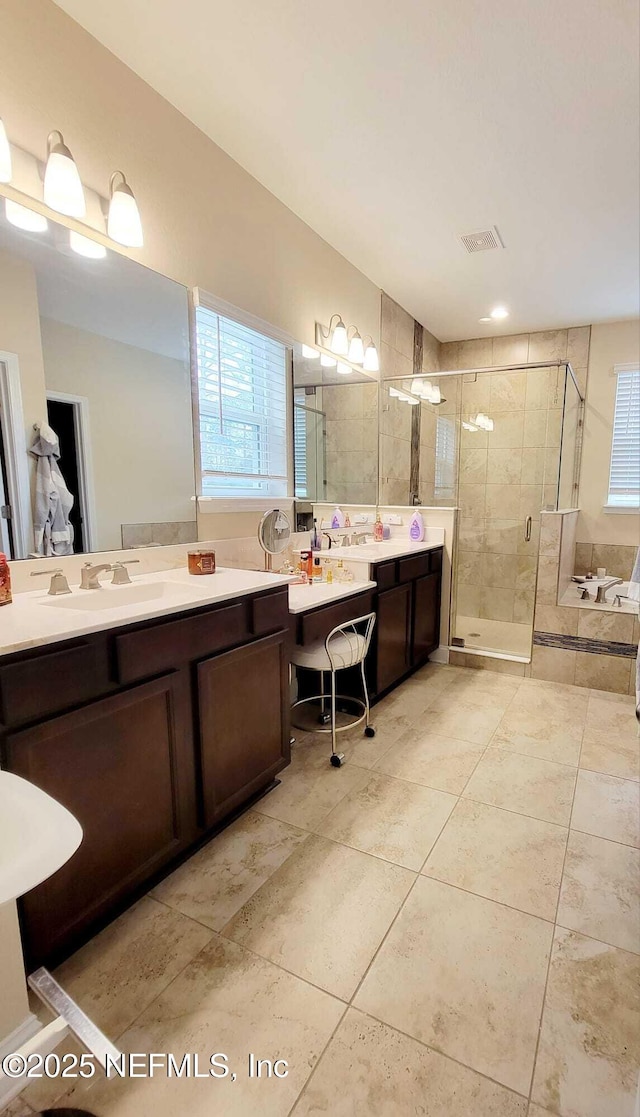 bathroom with vanity, tile patterned floors, and shower with separate bathtub