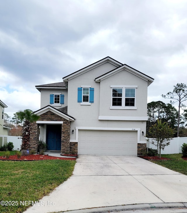 view of property featuring a garage and a front yard