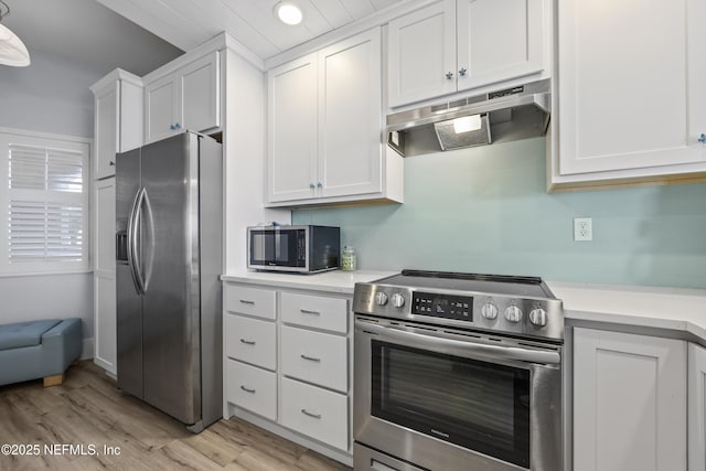 kitchen featuring appliances with stainless steel finishes, white cabinets, and light wood-type flooring