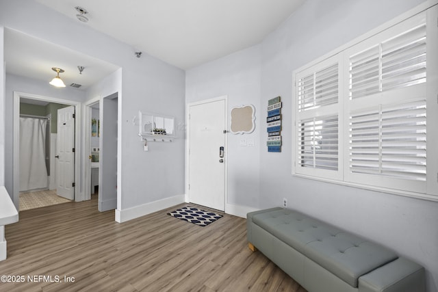 entryway with hardwood / wood-style flooring