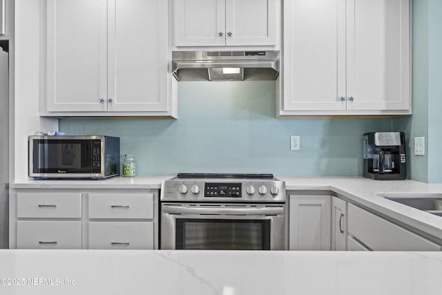 kitchen featuring white cabinetry, light stone counters, and stainless steel appliances