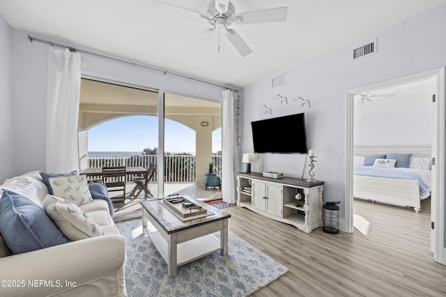 living room with ceiling fan and wood-type flooring