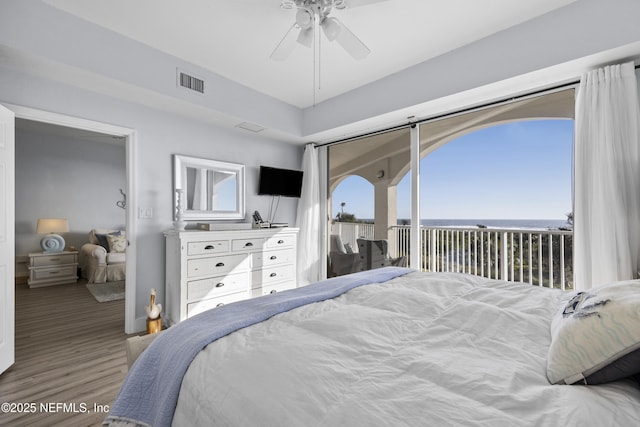 bedroom featuring hardwood / wood-style floors, access to exterior, and ceiling fan