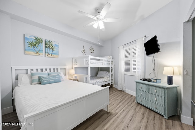 bedroom with ceiling fan and light hardwood / wood-style floors