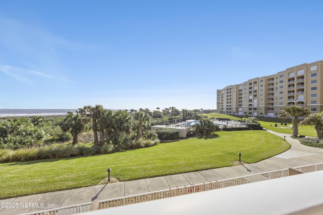 surrounding community featuring a water view and a yard