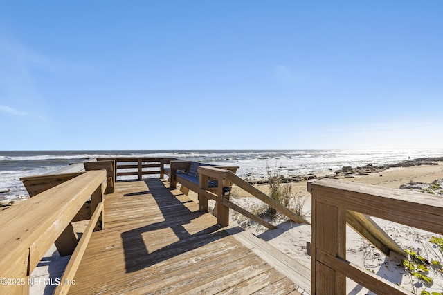 surrounding community featuring a view of the beach and a water view