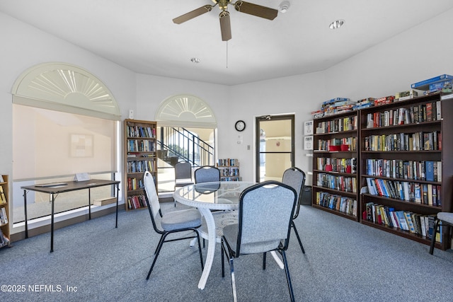 dining space featuring carpet flooring and ceiling fan