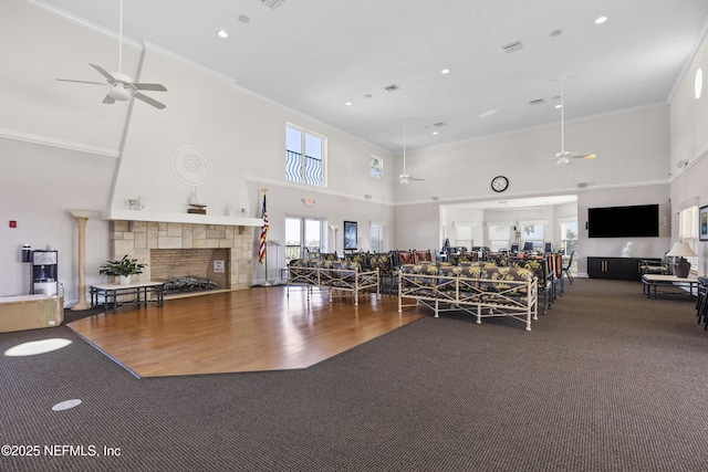 exercise room featuring ceiling fan, ornamental molding, and wood-type flooring